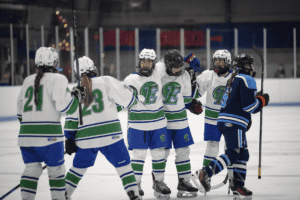 The East Green Wave celebrate a goal against the North Avalanche on Feb. 2. The Green Wave topped their foes 8-1 to advance to the state semifinals.